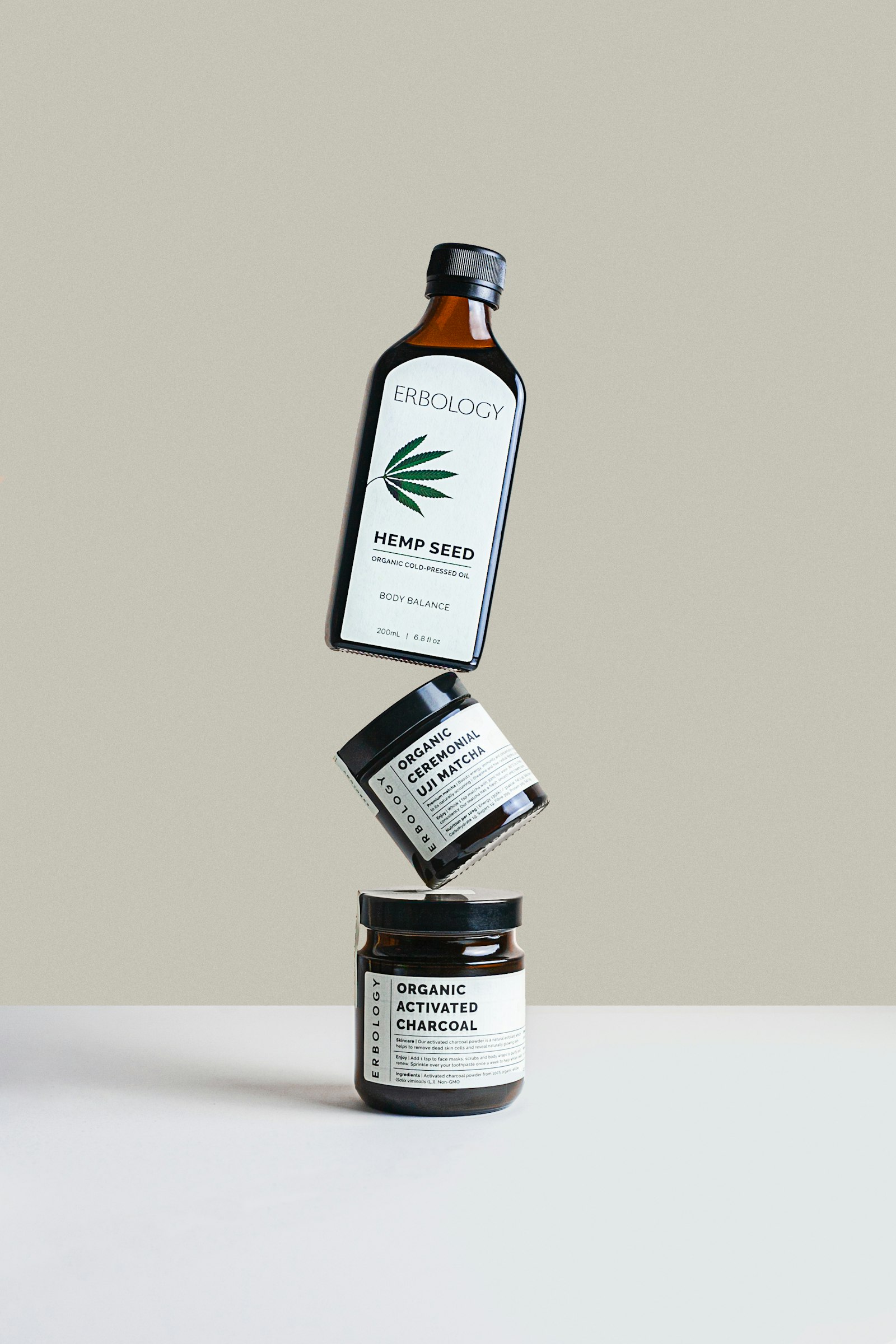 Amber glass dropper bottles and skincare packaging arranged on a dark surface